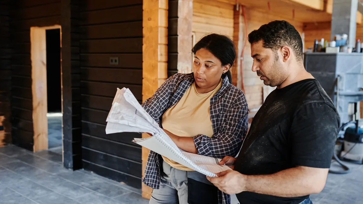 Homeowner and contractor reviewing a project estimate and site plan together
